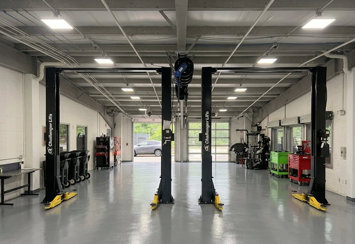 Two Challenger two-post lifts installed in a clean service bay