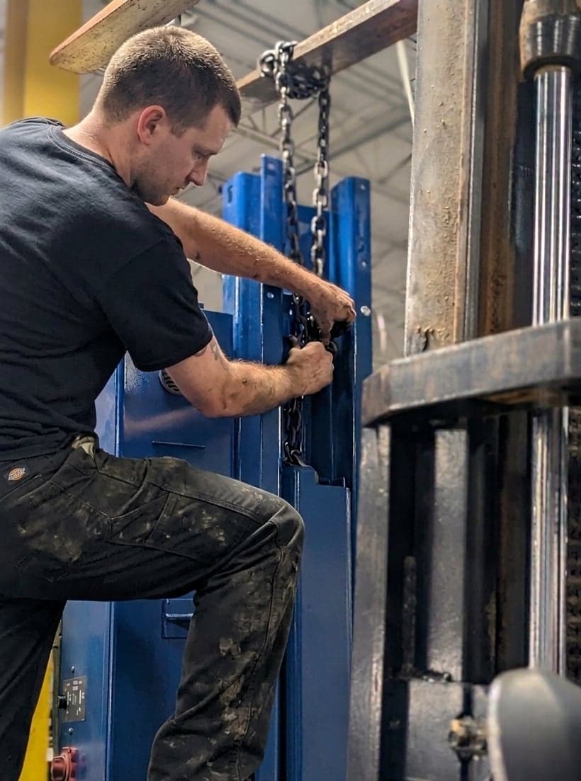 Technician adjusting the chain on a lift column