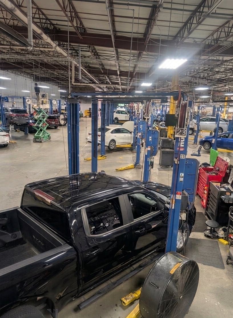 Dealership service floor with a truck staged at lift number 23